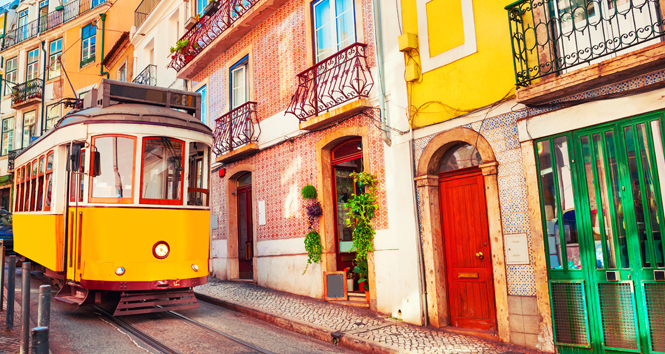 Yellow vintage tram on the street in Lisbon, Portugal